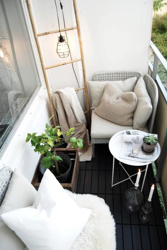 economically furnished terrace with small table and corner armchair