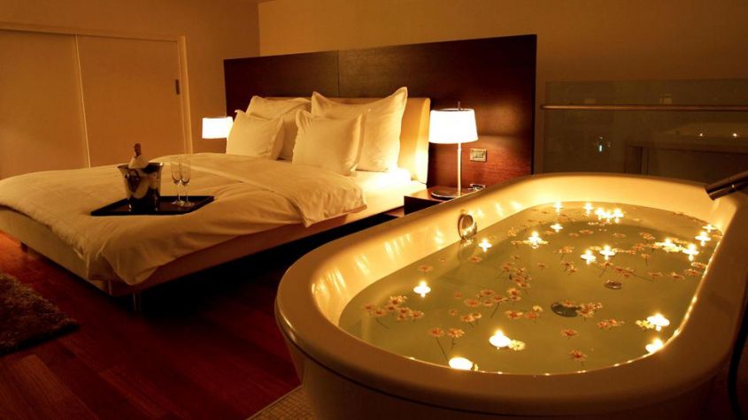 Flowers and candles in the bath in the room