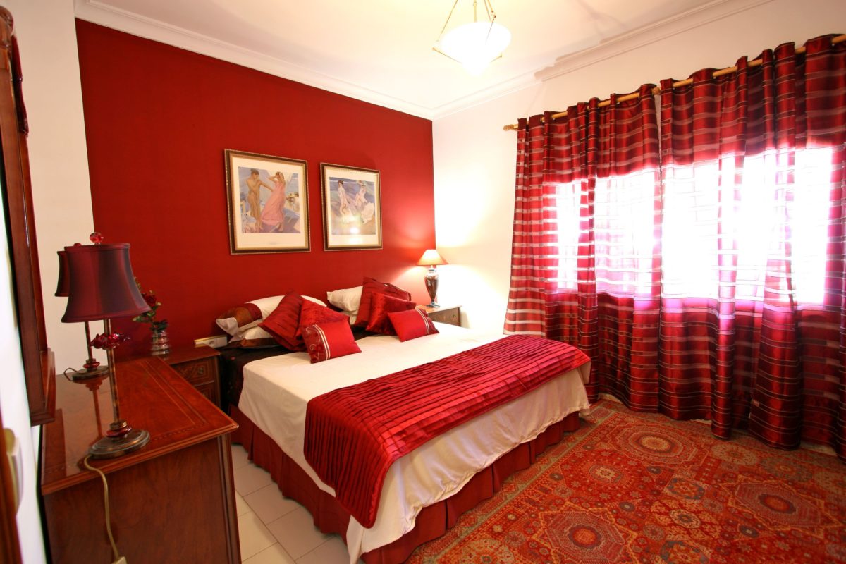 red bedroom with black furniture